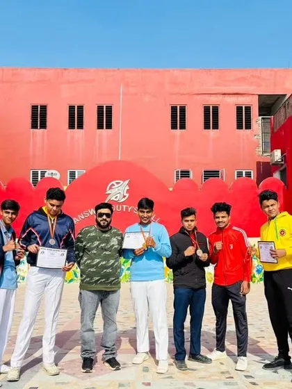 Standing proud with my medal-winning boxers in front of our school partner, Apex Public School.