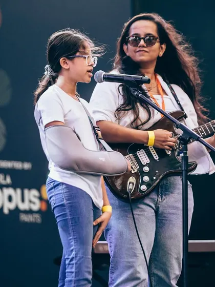 A student and mentor perform a duet at the Art Mumbai festival. Our mentors often join students on stage, providing support and making the experience even more special.