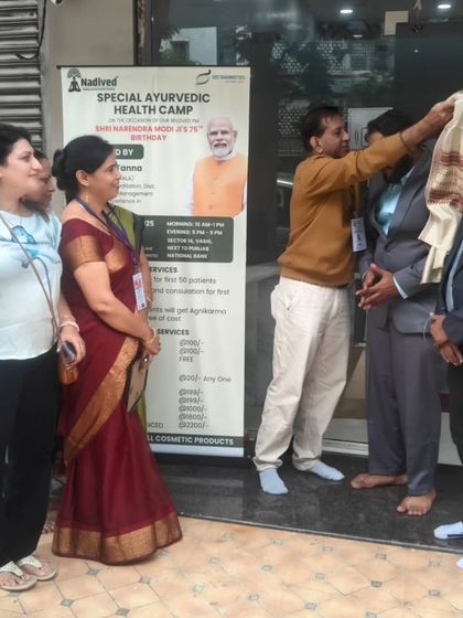 Being honored with a traditional shawl at the health camp. This event, organized on the Prime Minister's birthday, was our way of giving back to the community through selfless service (Seva).