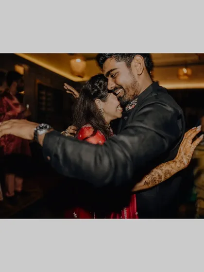 A warm, happy hug on the dance floor during the Sangeet.