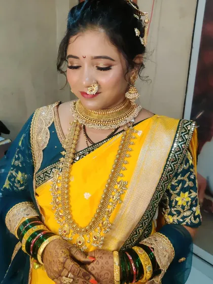 A close-up of Urmila's glowing makeup, featuring soft golden eyes and a traditional Marathi nath that completes the look.