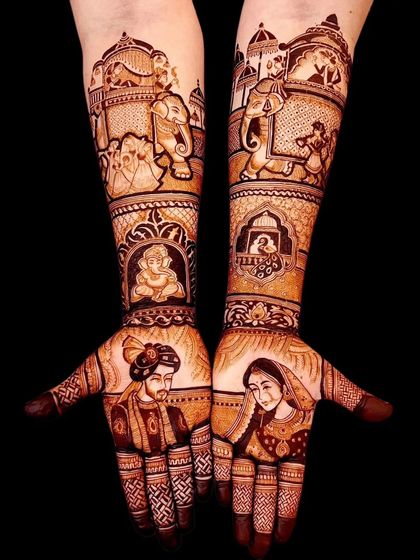 A classic portrait of a bride and groom, with Ganesha and a doli scene on the forearms, telling a complete wedding story.