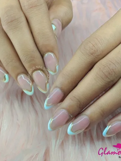 This design is the definition of modern elegance. We created a unique, wavy French tip effect with a soft blue and a crisp white, outlined with a delicate gold line. It's a subtle yet incredibly stylish look.