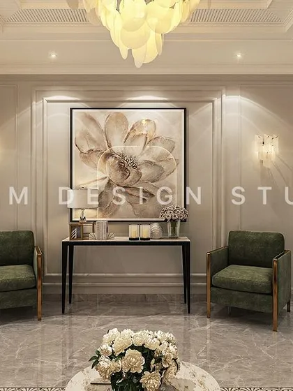 Symmetrical design is a hallmark of neoclassical style. Here, two green armchairs frame a console table and a large floral art piece, creating a balanced and elegant seating vignette.