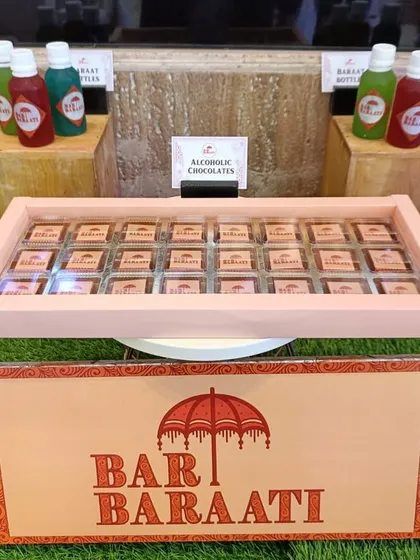 I can even create unique treats like these alcoholic chocolates. Presented in a custom tray with my 'Bar Baraati' branding, they offer a sophisticated and adult twist on a classic wedding favor.