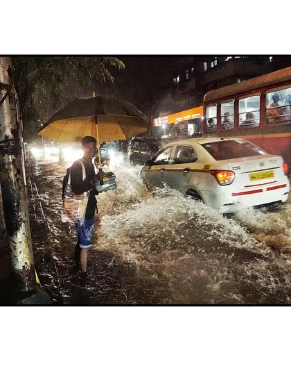 A powerful image of my delivery partner wading through heavy rain to make sure a corporate lunch is not missed.