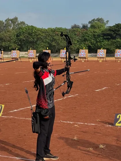 A student demonstrates her compound bow technique during the Senior State Archery Competition in Kolhapur.