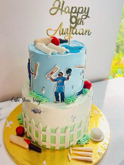 Cricket dreams and birthday cheers on this two-tier cake for a 9th birthday.
