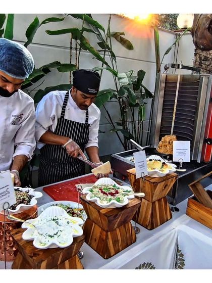 Our chefs at a live station, one slicing fresh parmesan cheese over a dish. This highlights our use of high quality, authentic ingredients and the finishing touches that elevate each plate.