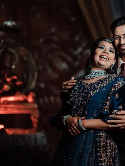 A joyful and candid reception photo. The bride's big laugh shows the fun and happiness of the celebration.