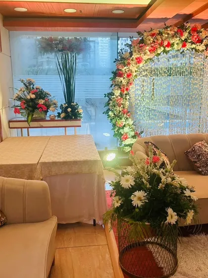 A complete view of the Roka ceremony seating area, showing the main sofa, side tables, and floral arrangements that create a cohesive and beautiful look.