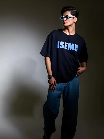 This shot features a dark graphic tee against a simple studio background. I styled it with baggy jeans and light-colored sunglasses for a classic, cool streetwear look.