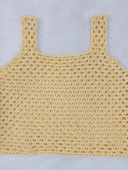 A flat-lay of the Ophelia Tank Top, showing the delicate mesh stitch and clean construction.