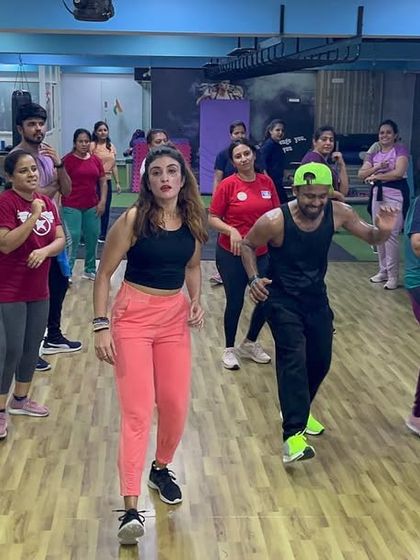 Members moving in sync during a fast-paced part of the Zumba workout.