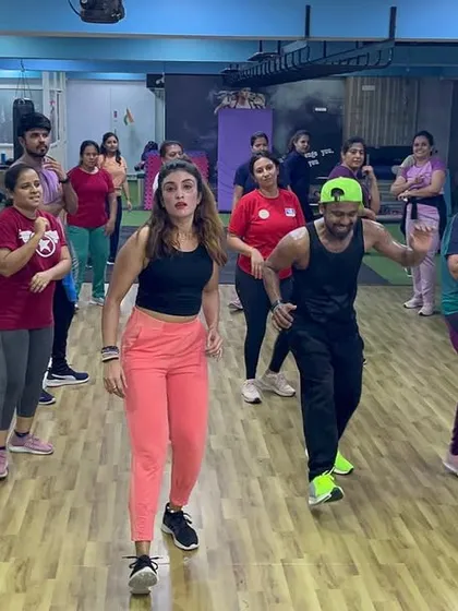 Members moving in sync during a fast-paced part of the Zumba workout.