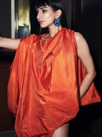 A closer view of the hand-sculpted silk dress, showcasing its vibrant color and voluminous drape.