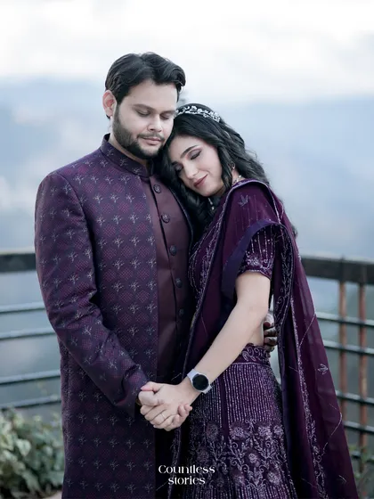 A tender moment captured with the mountains as their witness. She rests her head on his shoulder, a picture of peace and trust. This portrait focuses on their connection, framed by the soft, diffused light of the scenic location.