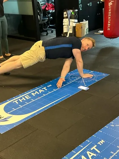 An instructor demonstrates a core stability test on the MAT. This tool allows for standardized, repeatable assessments of an athlete's physical capabilities.