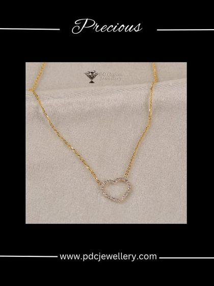 A precious heart-shaped diamond pendant on a lightweight gold chain. This is a classic symbol of love, perfect for gifting or as a personal everyday piece.