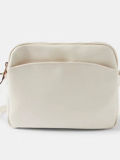 A front view of the off-white Australia Crossbody bag. The gold hardware gives it a classic and polished finish.