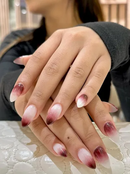A dramatic and beautiful ombré, fading from a deep, rich red to a crisp white. This look is bold and unforgettable.