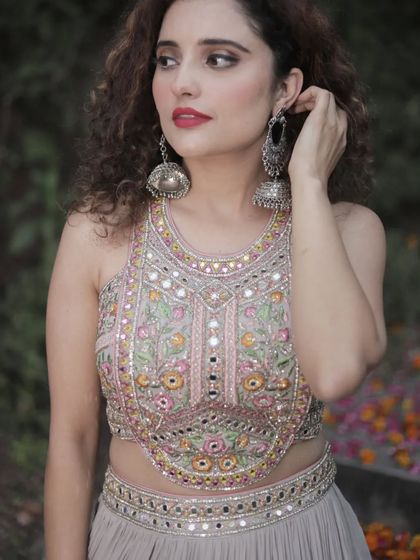 A close-up of the stunning mirror and thread work on the blouse of our grey party lehenga. The intricate detailing makes it a true showstopper.