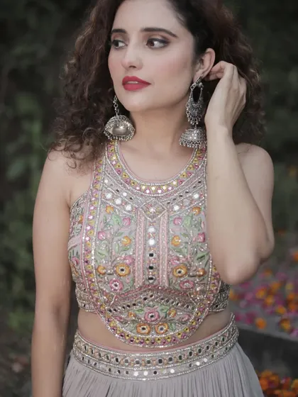 A close-up of the stunning mirror and thread work on the blouse of our grey party lehenga. The intricate detailing makes it a true showstopper.