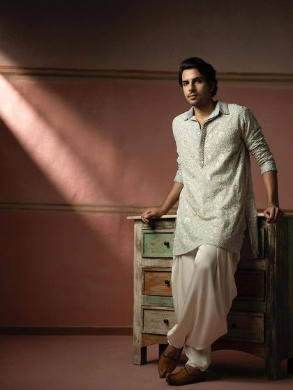 A menswear look from 29 India, featuring a powder blue chikankari kurta styled in our room corner set.
