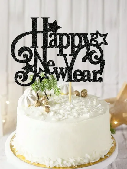 A "Happy New Year" topper in black glitter with star and swirl details, adding a festive touch to your party.