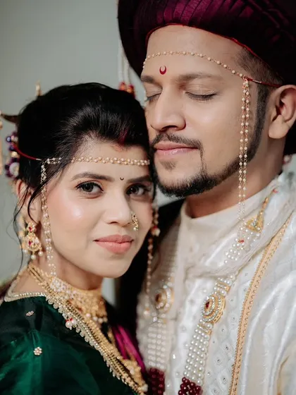 A close-up, intimate portrait of the couple. The bride's soft makeup and the groom's coordinated look create a beautiful frame.