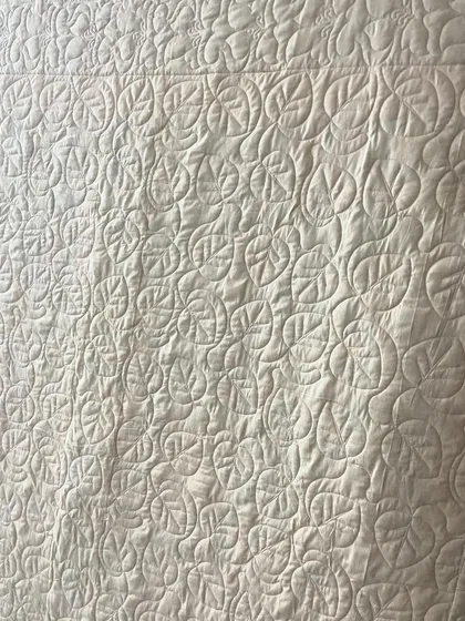 Another detail shot of the quilting on the back, showing a leaf-like motif.