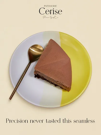 Precision never tasted this seamless. A perfectly smooth slice of a chocolate entremet, showcasing the technique and restraint that defines my work.