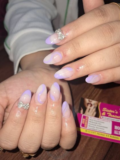 A pretty pastel purple design with abstract swirls and 3D stone bows for a cute and glamorous finish.