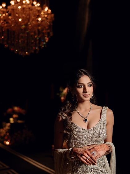 An artistic shot of this radiant cocktail look. The dramatic lighting highlights the glowing skin and the intricate details of her Gaurav Gupta outfit.