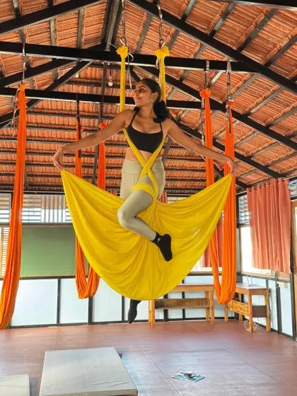 Another beautiful skirt pose, with the student spreading the yellow hammock like wings. This pose is a favorite for its beauty and sense of freedom.