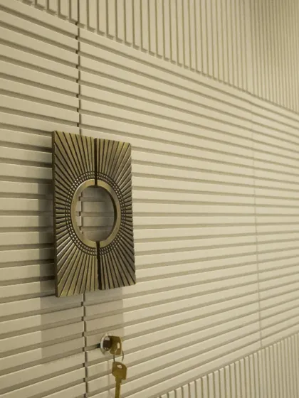 A close-up of the custom hardware and intricate fluting on this bespoke wardrobe. Every detail is chosen to complement the overall design and add a touch of luxury.