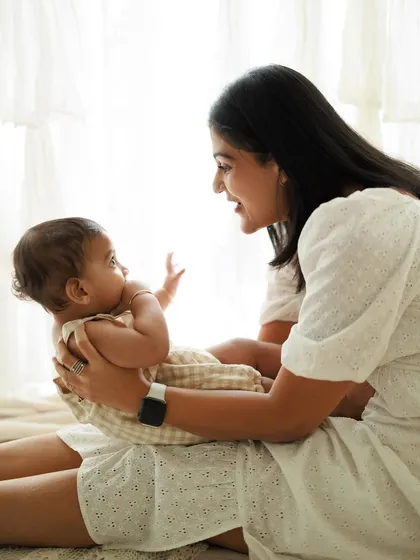 A mother's gaze is full of unspoken love. This candid shot from a lifestyle session captures a beautiful, natural interaction between a mom and her baby.