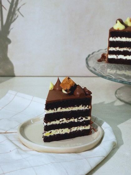 A slice of Chocolate Heaven, showcasing the contrast between the dark sponge and the white buttercream layers. It's a complex cake with a satisfying mix of flavors and textures.