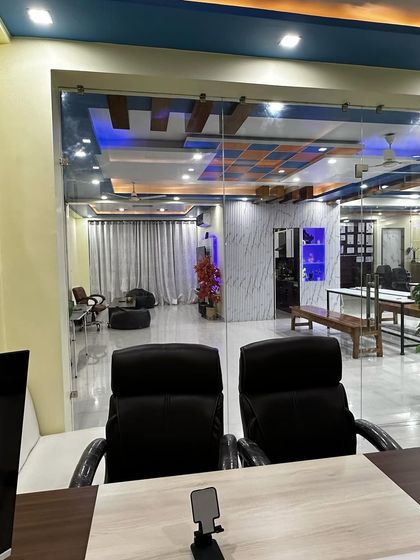 A view from inside a cabin looking out into the main office area, showcasing the transparent and modern design of our new workspace.
