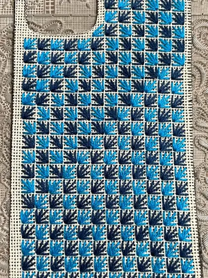 This phone insert showcases a checkerboard-like pattern using a fan stitch, creating a lovely texture.