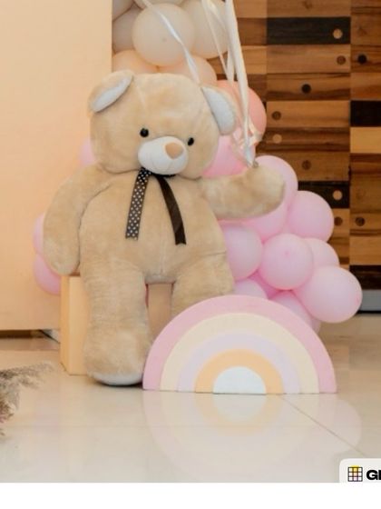 A duplicate image of the cute teddy bear prop with a rainbow.