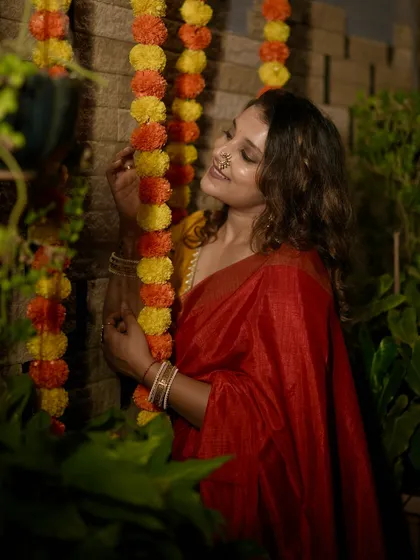 A candid moment during my Diwali celebration, with marigold flower decorations complementing the festive saree.