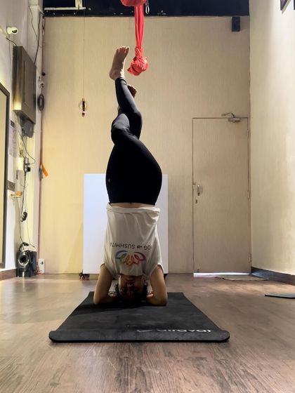 Good vibes only. A moment of playful balance in a headstand variation, with legs in Garudasana (eagle pose).