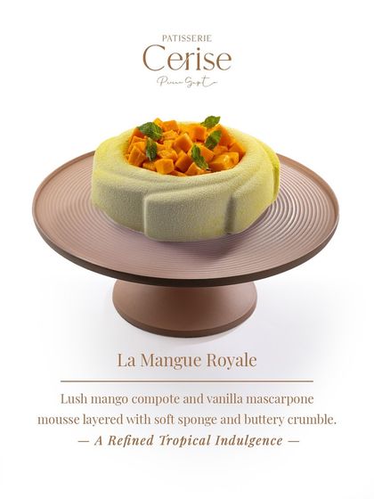 This is La Mangue Royale, a refined tropical indulgence. It features a lush mango compote and vanilla mascarpone mousse, layered with soft sponge and a buttery crumble for texture.