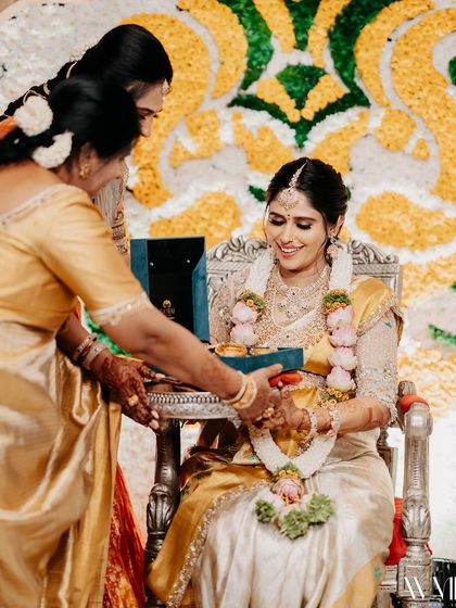 A candid moment from my baby shower, as family members perform traditional rituals.