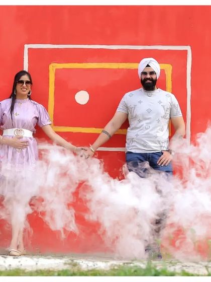A fun and colorful pre-wedding photo with a vibrant backdrop and smoke effects. This kind of shot is perfect for couples who want something playful and energetic.