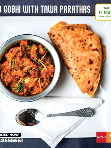 A simple, homestyle favorite: Aloo Gobhi with Tawa Parathas. This dry vegetable dish made with potatoes and cauliflower is lightly spiced and tastes just like it's made at home.