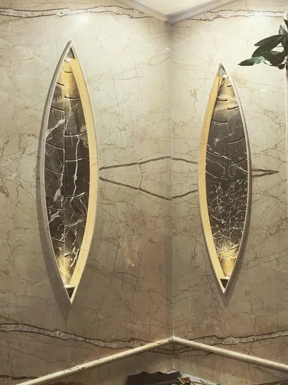 Attention to detail is central to our work. This entrance detail features custom-shaped marble cladding with integrated backlighting, creating a sophisticated and memorable first impression for a private residence.