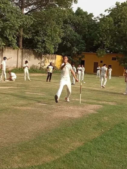 A bowler completes his follow-through during a practice session on the main ground. We provide dedicated coaching to refine bowling actions, increase pace, and develop variations.