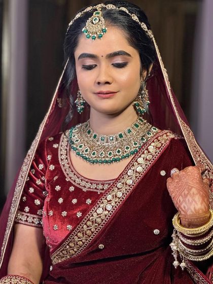 The complete look, radiating elegance and grace. The makeup is perfectly balanced with the rich color of her velvet outfit.